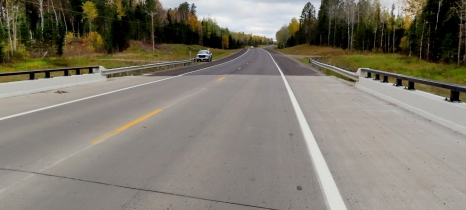 Wide shoulders flank a highway bridge crossing