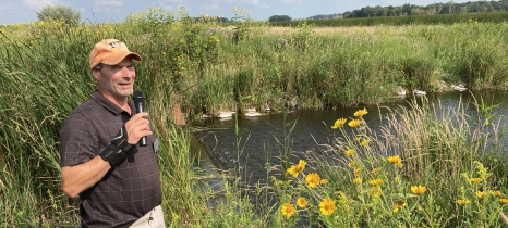 Man stands next to wetland