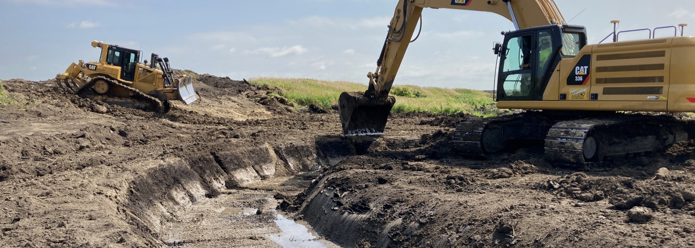 backhoe working for improvements to creek.